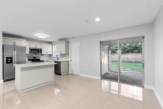 a kitchen with stainless steel appliances a refrigerator sink and stove
