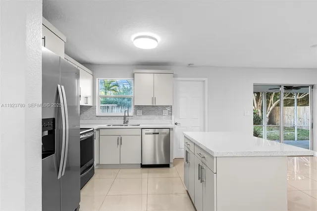 a kitchen with a sink stove and refrigerator