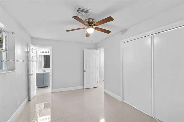 a view of a livingroom with a ceiling fan and window
