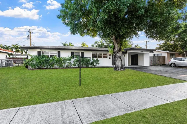 a front view of building with yard and green space
