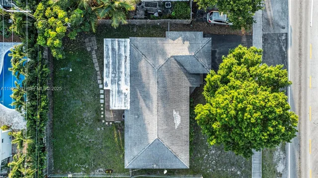 an aerial view of a house with a yard