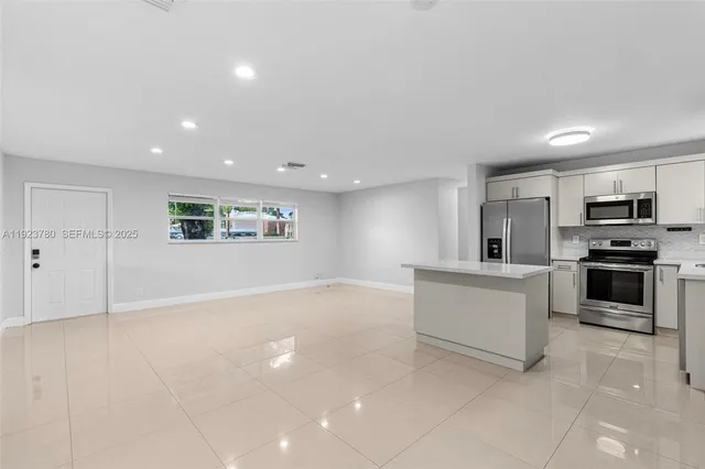 a view of kitchen with cabinets and microwave