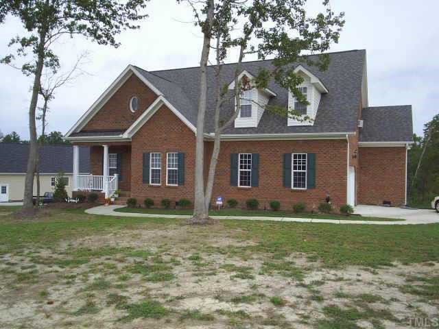 1024 Shellfish Drive Willow Spring, NC 27592 - Photo 1 of 1 a view of a yard in front of a house with large tree