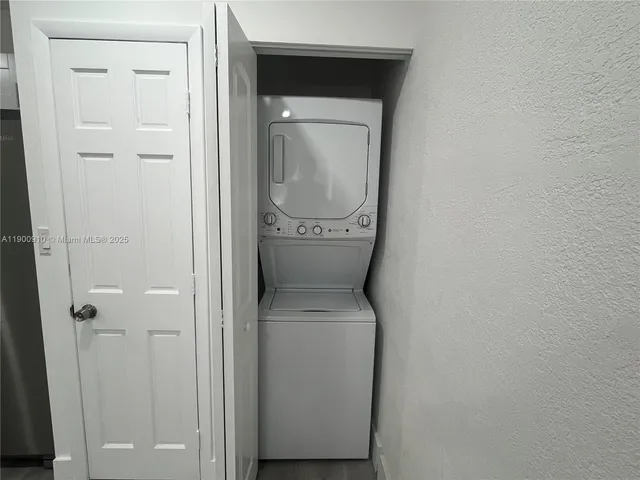 a kitchen with a sink a refrigerator and window