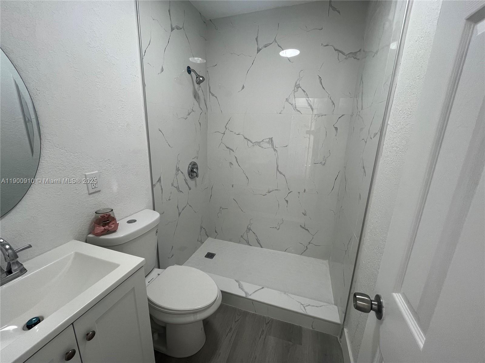 1923 Northwest 66th Street Miami, FL 33147 - Photo 23 of 27 a bathroom with a sink toilet and shower
