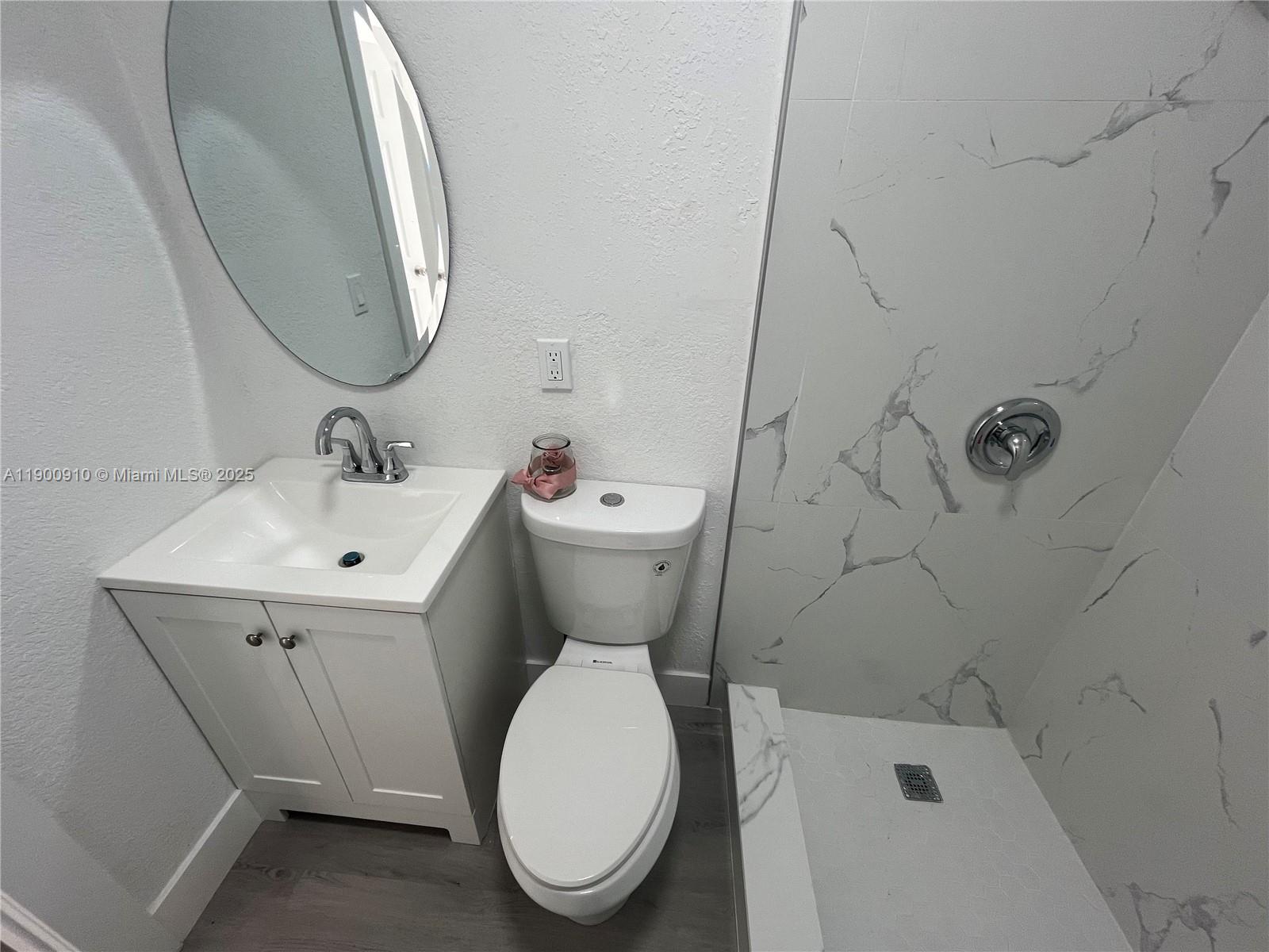 1923 Northwest 66th Street Miami, FL 33147 - Photo 24 of 27 a bathroom with a toilet sink and mirror