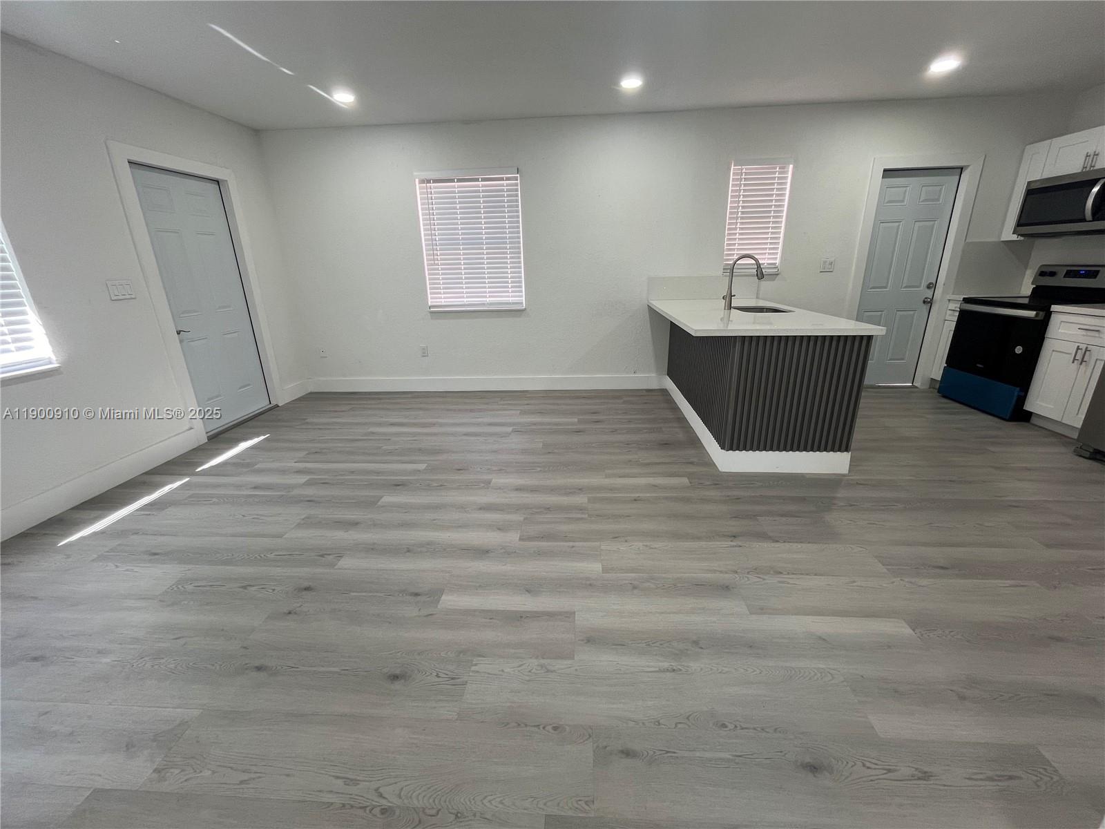 1923 Northwest 66th Street Miami, FL 33147 - Photo 7 of 27 a view of kitchen and windows