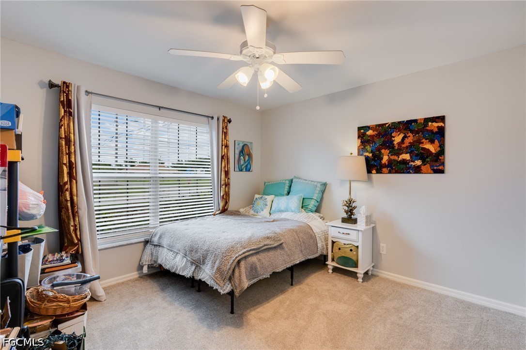 3801 28th Street Southwest Lehigh Acres, FL 33976 - Photo 16 of 37 a bedroom with a bed and a window