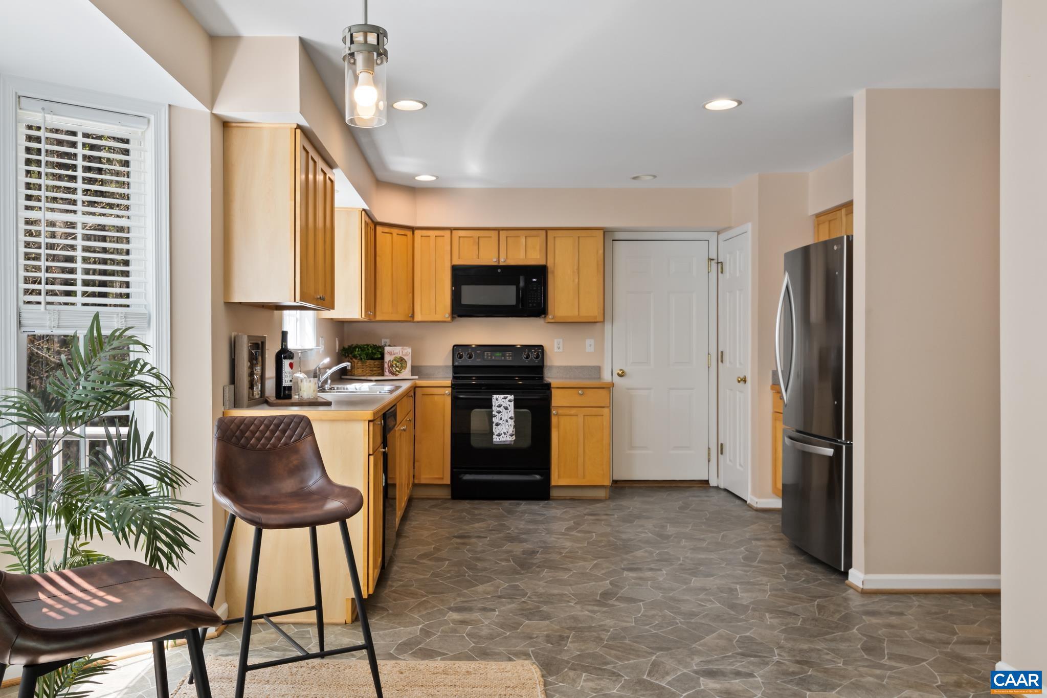 96 Red Cedar Road Barboursville, VA 22923 - Photo 15 of 59 a kitchen with a refrigerator and a stove top oven
