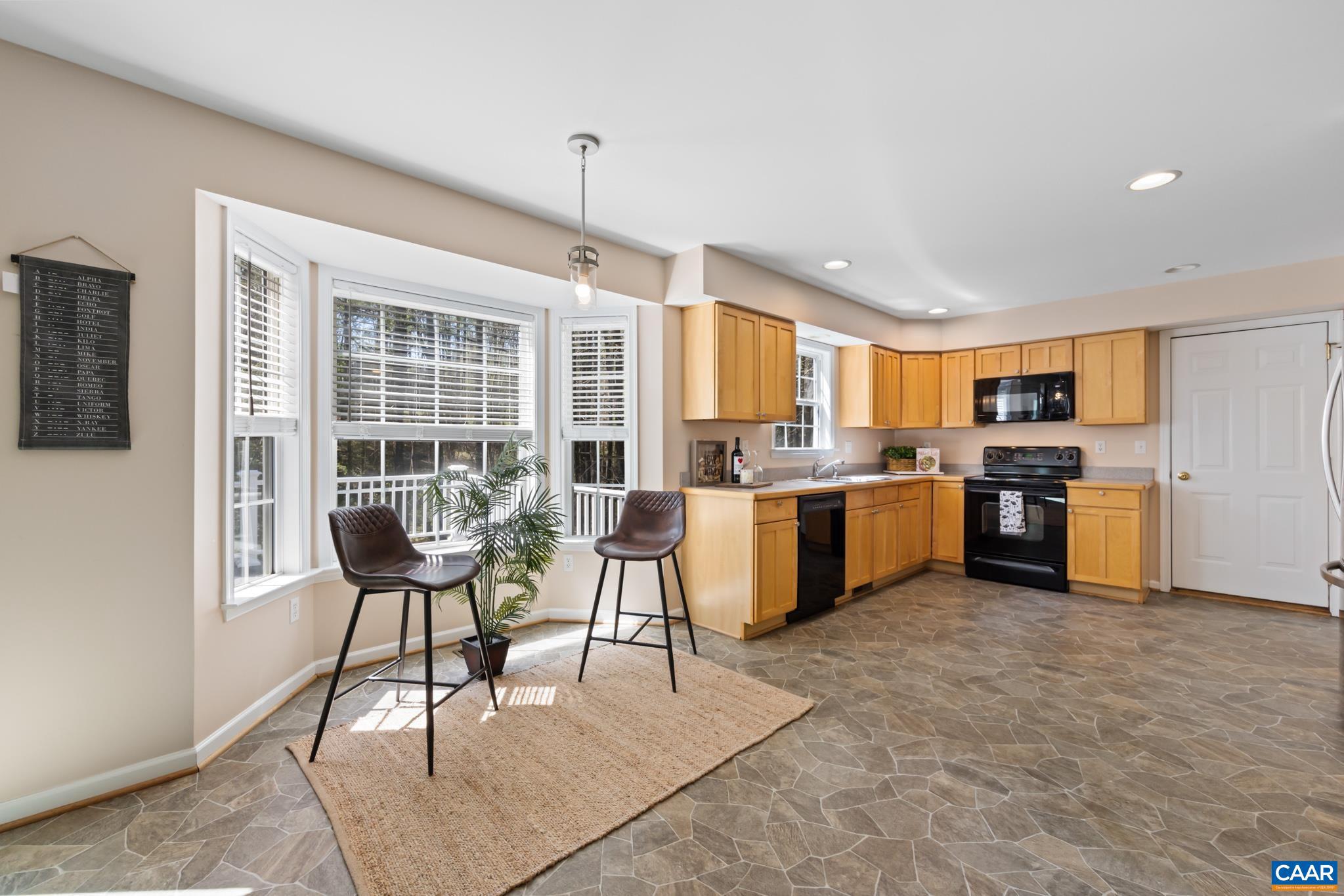 96 Red Cedar Road Barboursville, VA 22923 - Photo 16 of 59 a living room with stainless steel appliances kitchen island granite countertop furniture and a kitchen view