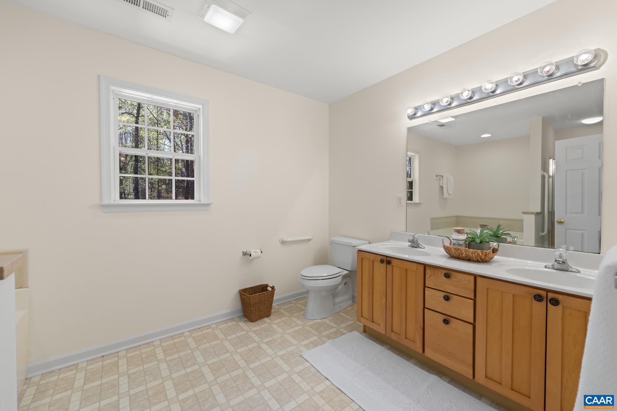 96 Red Cedar Road Barboursville, VA 22923 - Photo 29 of 59 a spacious bathroom with a double vanity sink a toilet and a mirror