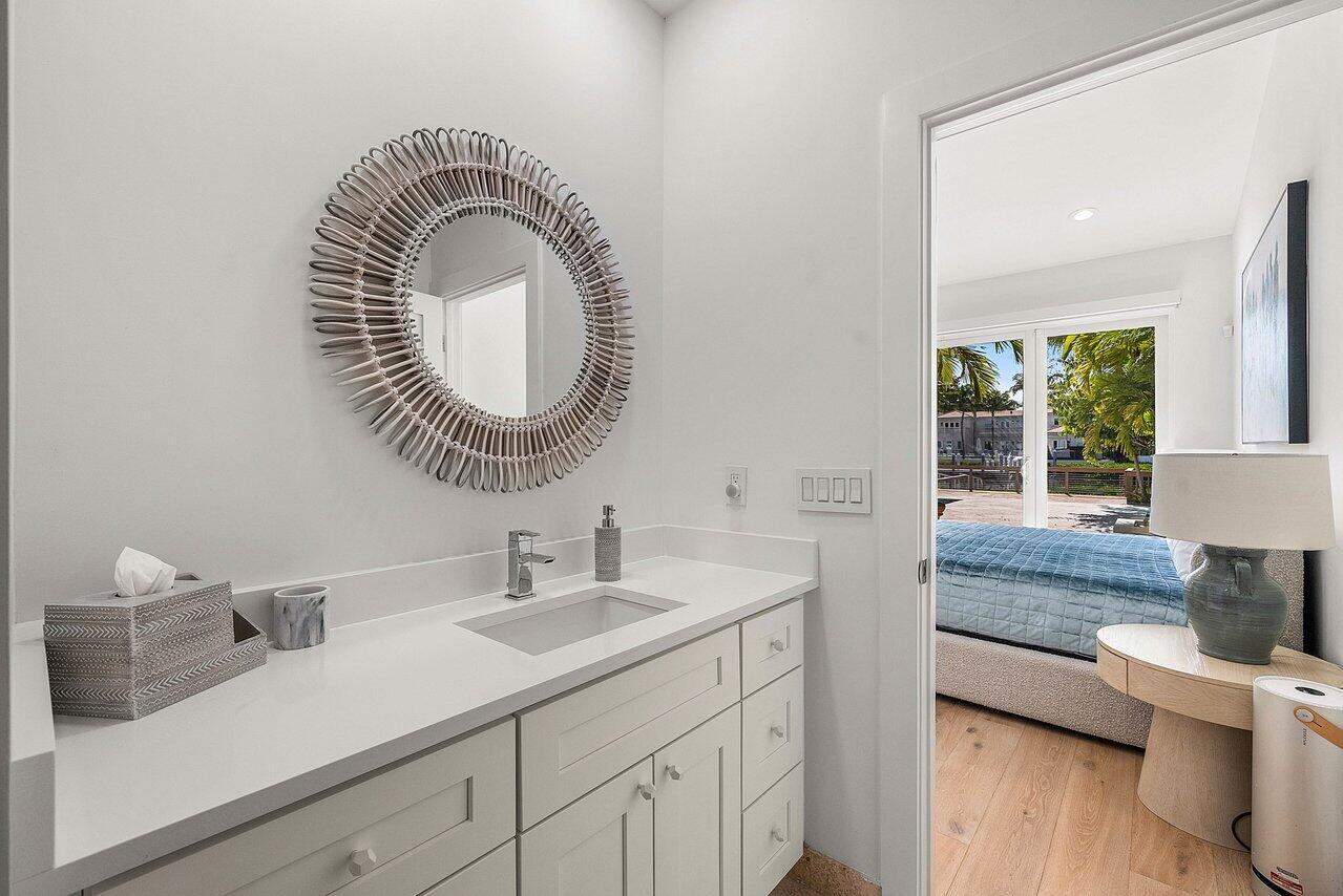215 Island Drive Jupiter, FL 33477 - Photo 36 of 69 a bathroom with a granite countertop sink and a mirror