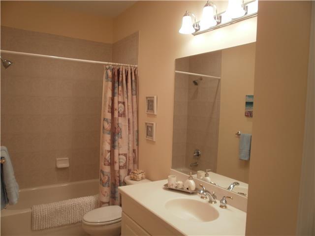 219 Southwest Walking Path Stuart, FL 34997 - Photo 17 of 24 a bathroom with a sink a toilet and shower