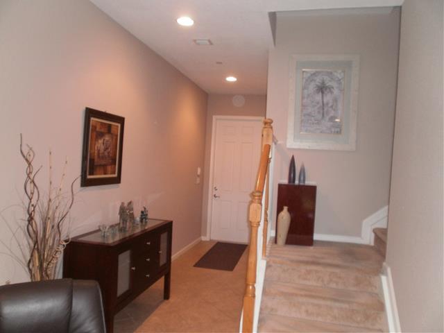 219 Southwest Walking Path Stuart, FL 34997 - Photo 4 of 24 a living room with furniture and a lamp