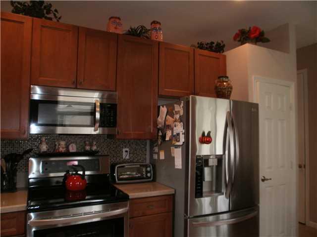 219 Southwest Walking Path Stuart, FL 34997 - Photo 6 of 24 a kitchen with stainless steel appliances granite countertop a refrigerator and a stove