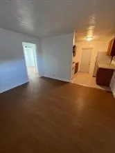 a view of a room with wooden floor and chair