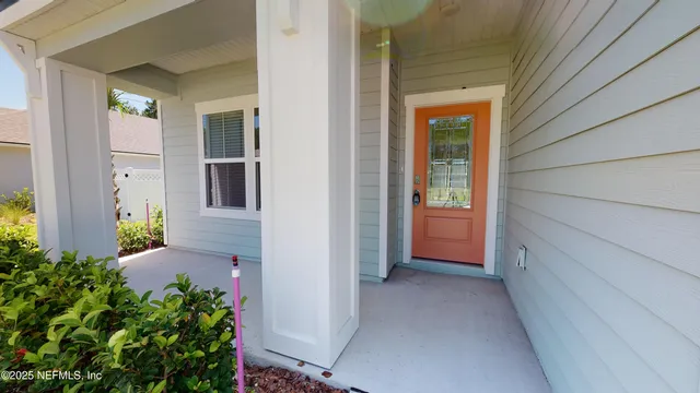 a view of a hallway with wooden walls and plants