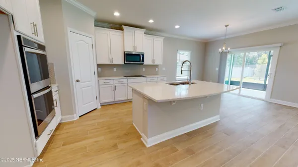 a kitchen with a sink stainless steel appliances and counter space
