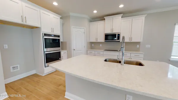 a kitchen with granite countertop a refrigerator and a sink