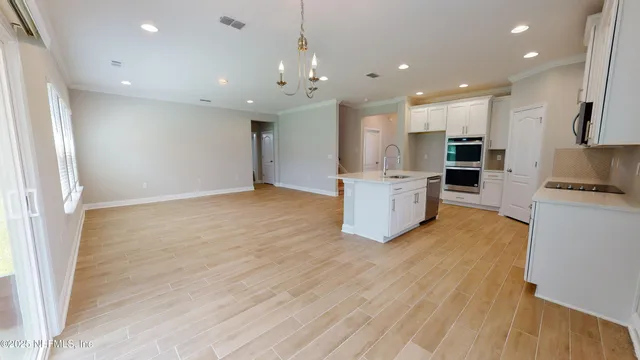 a view of kitchen with sink and refrigerator