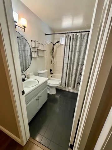 a bathroom with a toilet sink and mirror