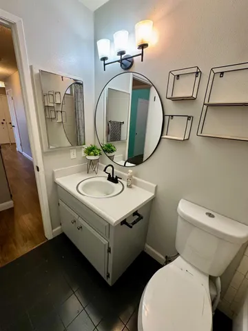 a view of a room with a ceiling fan and wooden floor