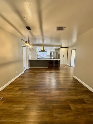a view of a room with wooden floor