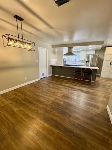 a view of a room with wooden floor