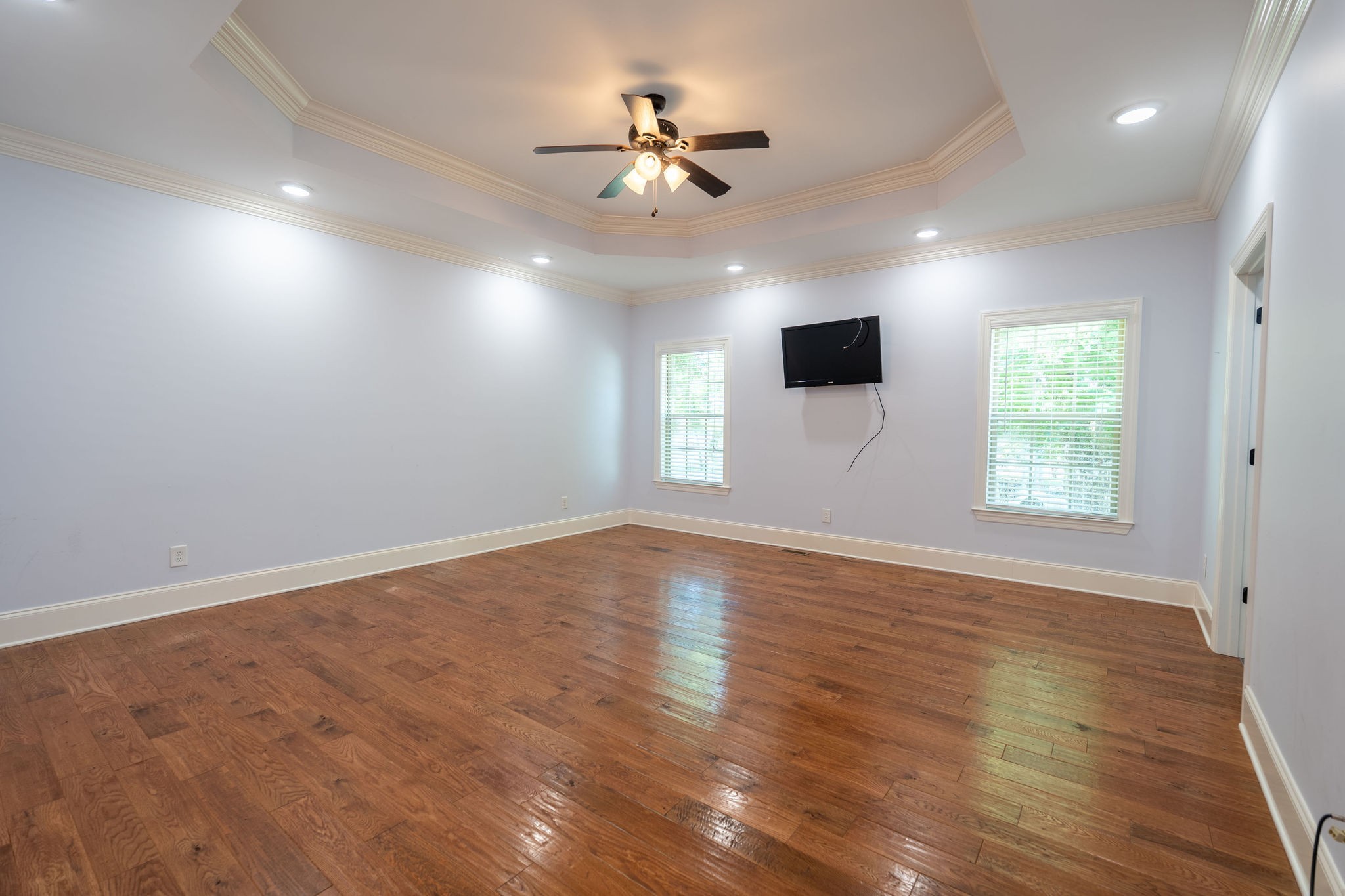 219 Waterloo Street Lawrenceburg, TN 38464 - Photo 12 of 39 an empty room with wooden floor ceiling fan and windows