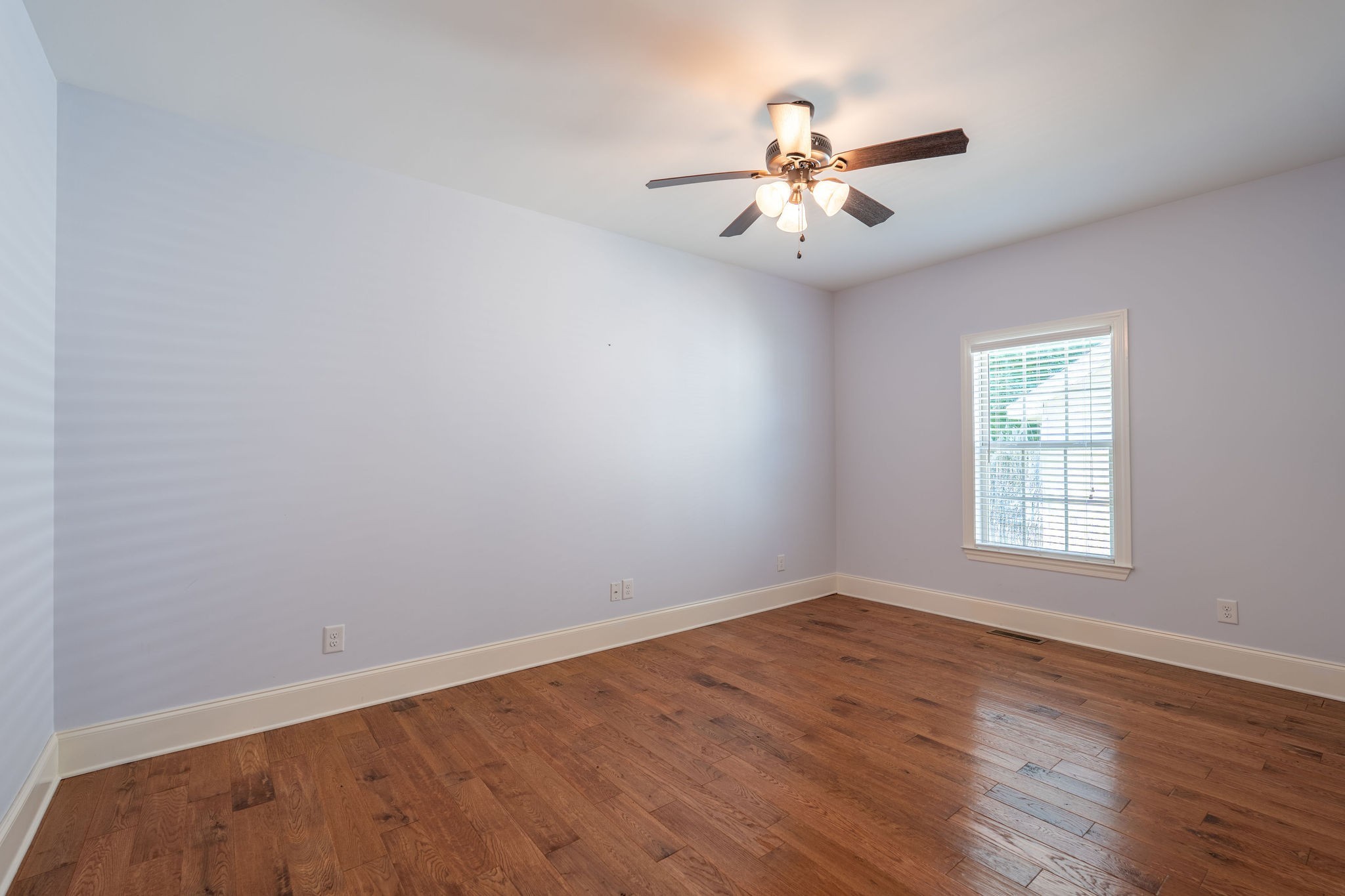 219 Waterloo Street Lawrenceburg, TN 38464 - Photo 18 of 39 an empty room with wooden floor fan and windows