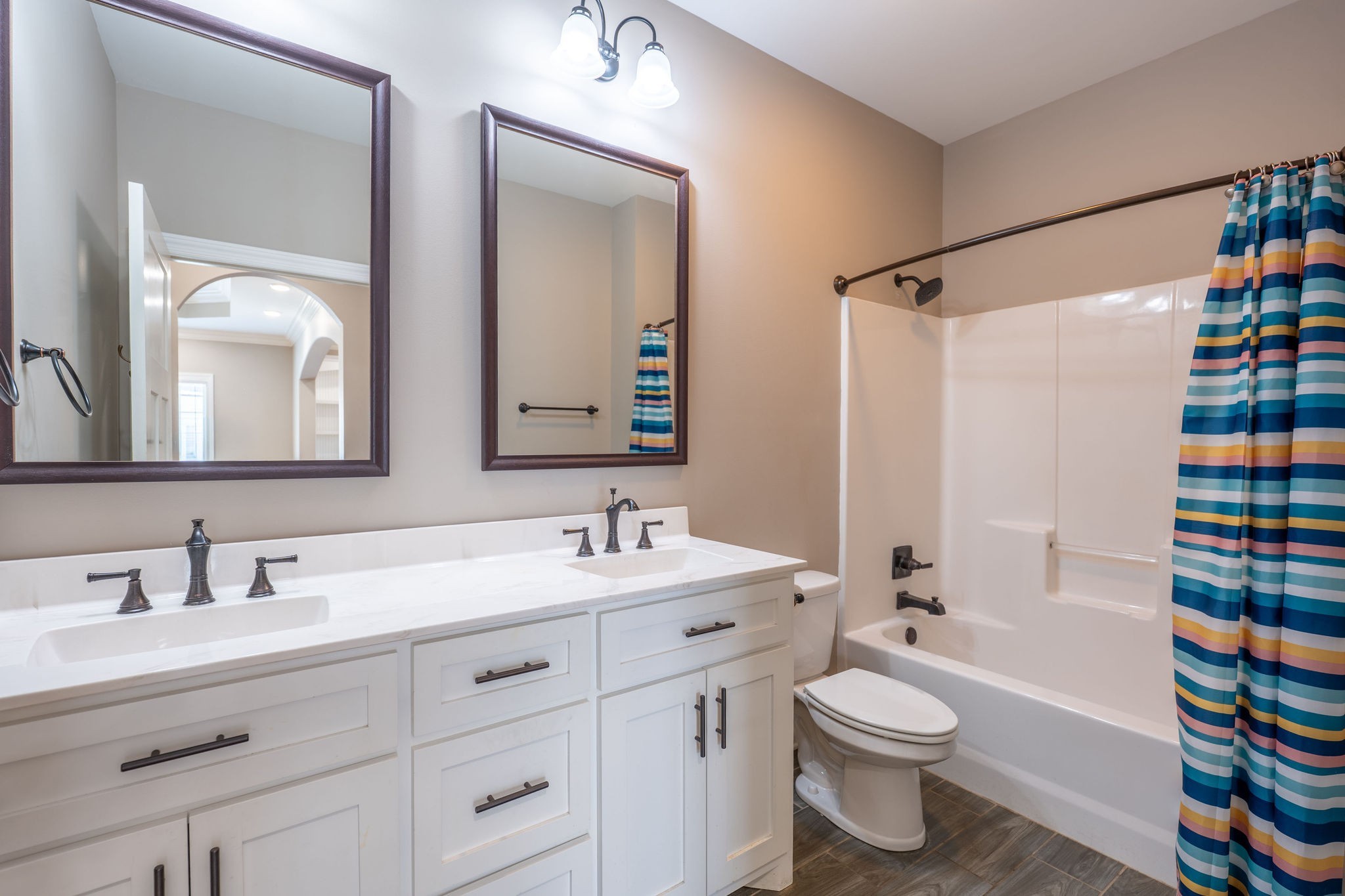 219 Waterloo Street Lawrenceburg, TN 38464 - Photo 19 of 39 a bathroom with a toilet a sink and a large mirror