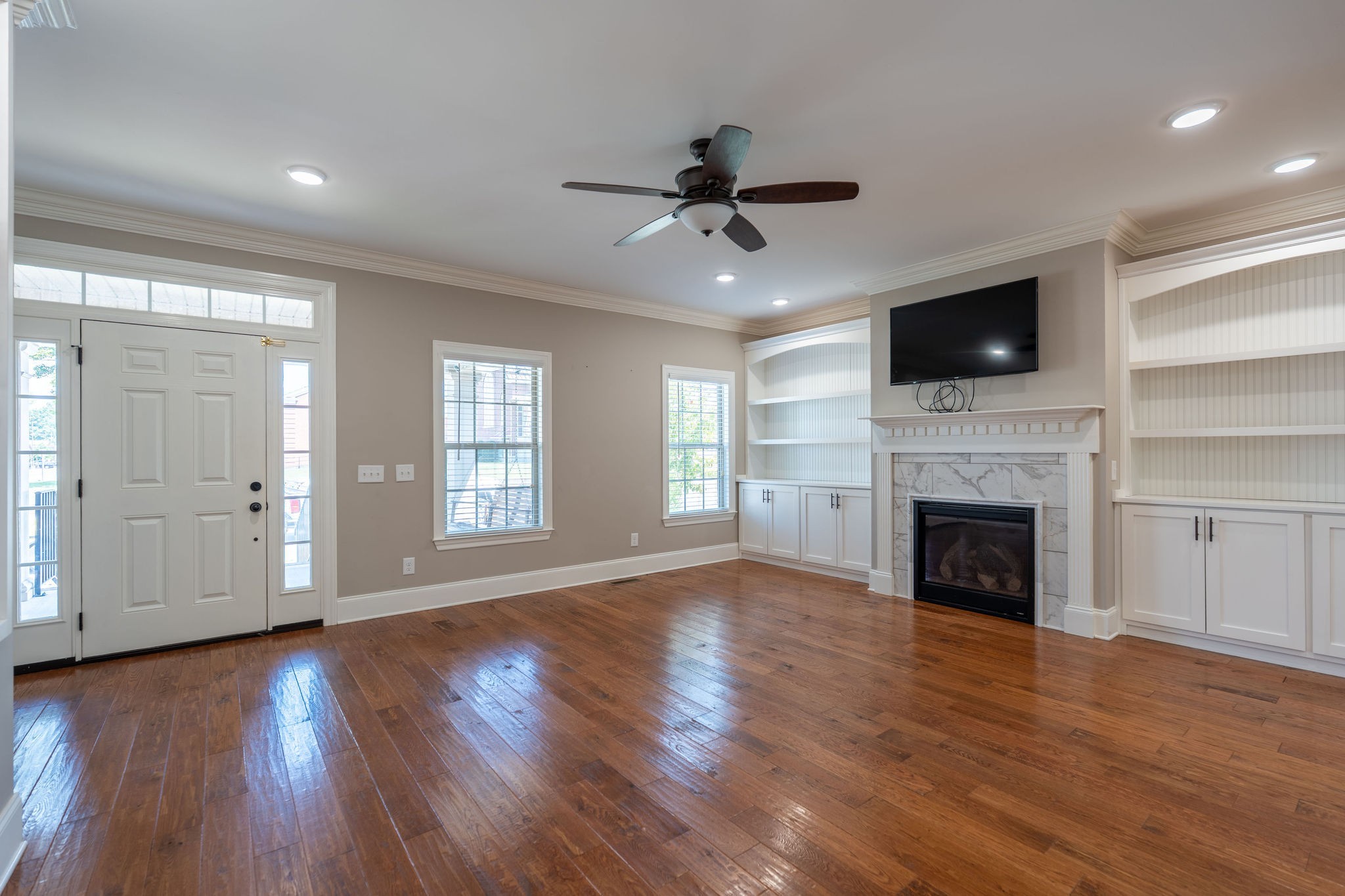 219 Waterloo Street Lawrenceburg, TN 38464 - Photo 7 of 39 a view of a livingroom with fireplace wooden floor and windows