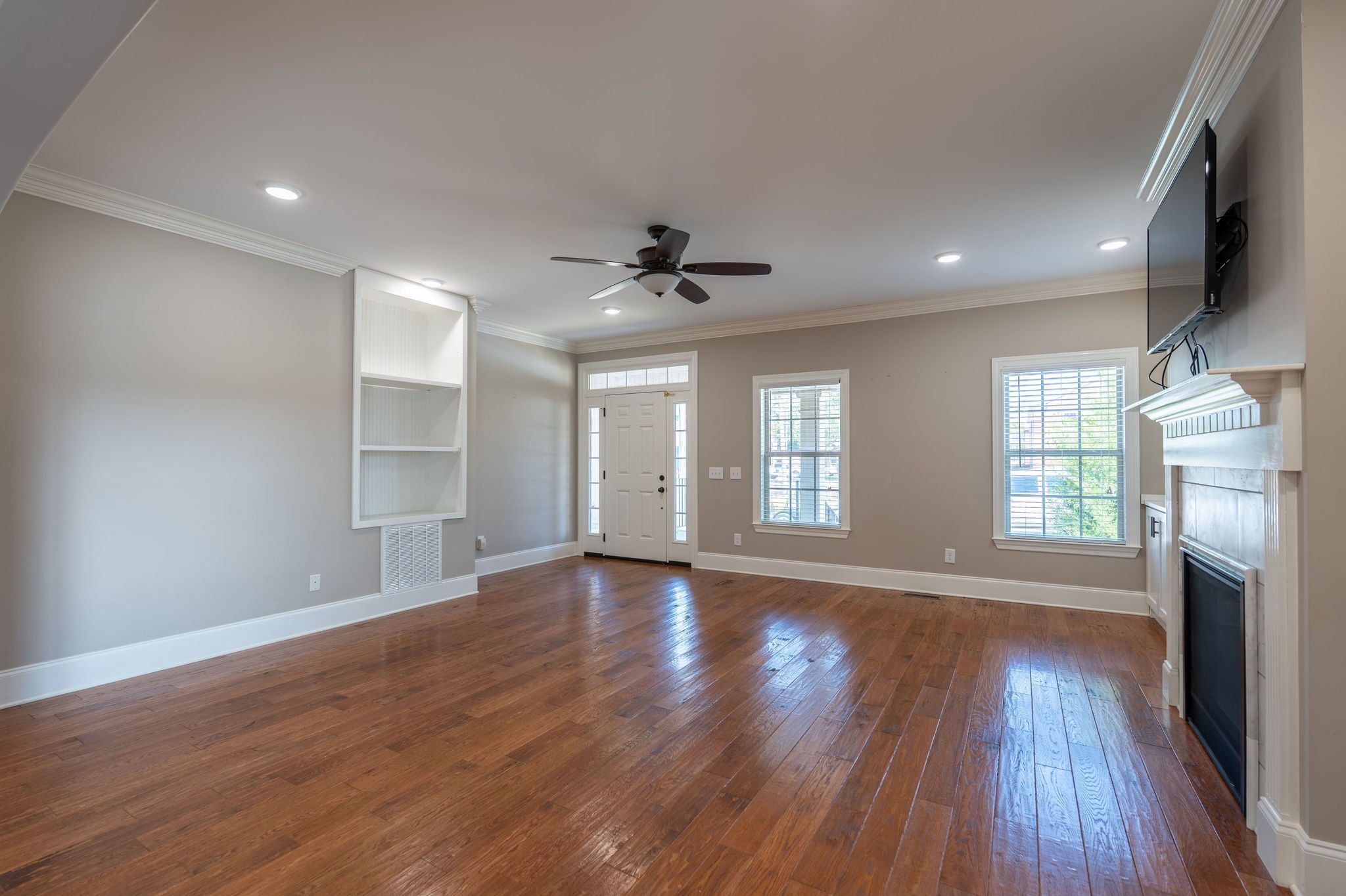 219 Waterloo Street Lawrenceburg, TN 38464 - Photo 8 of 39 a view of an empty room with wooden floor and a window
