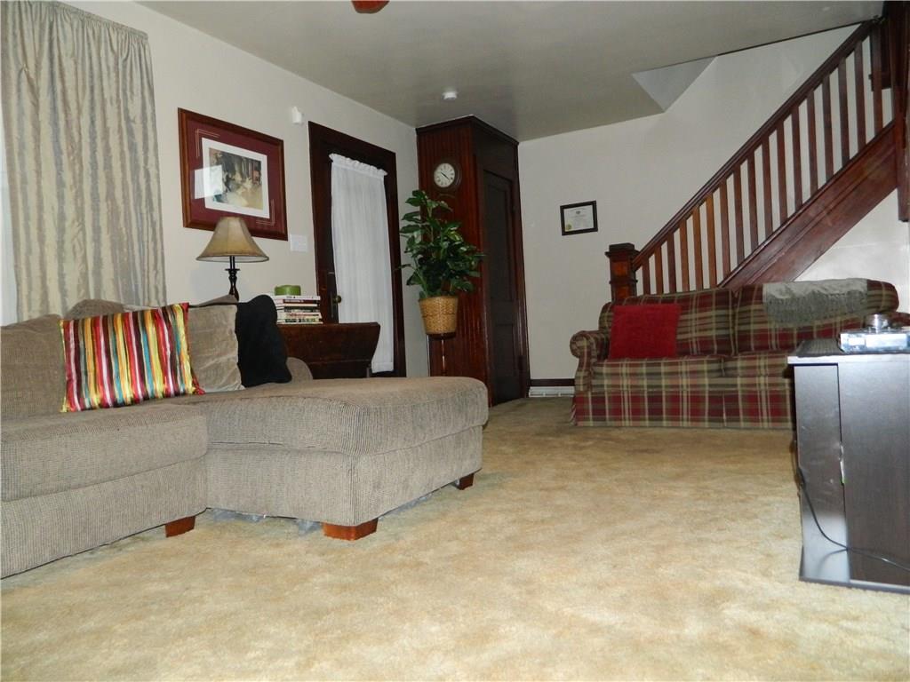 1050 Winfield Road Cabot, PA 16023 - Photo 3 of 23 THE FRONT DOOR WELCOMES YOU INTO THE SPACIOUS LIVING ROOM WITH BEAUTIFUL WOOD TRIM
