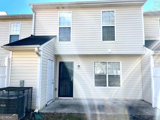a view of a house with a yard and garage
