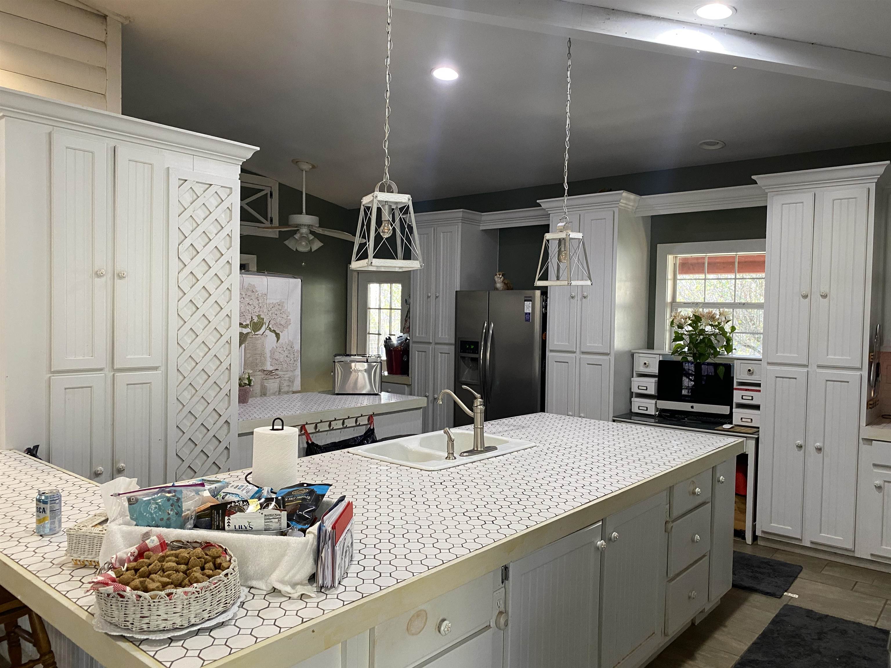 2835 Cerro Gordo Road Olivehill, TN 38475 - Photo 12 of 40 a kitchen with stainless steel appliances kitchen island granite countertop a sink dishwasher a refrigerator and a dining table with garden view
