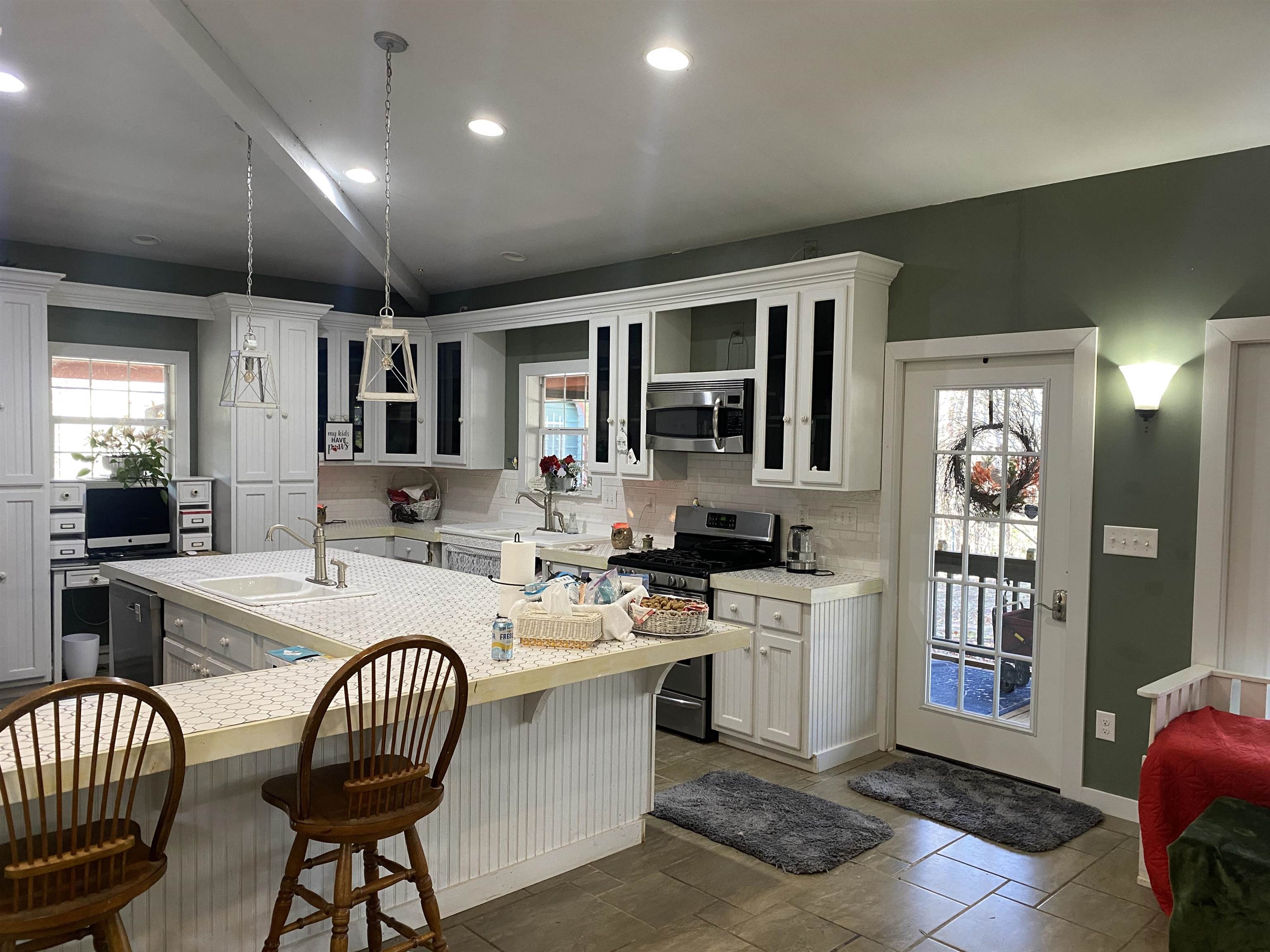 2835 Cerro Gordo Road Olivehill, TN 38475 - Photo 10 of 40 a kitchen with sink a stove and chairs