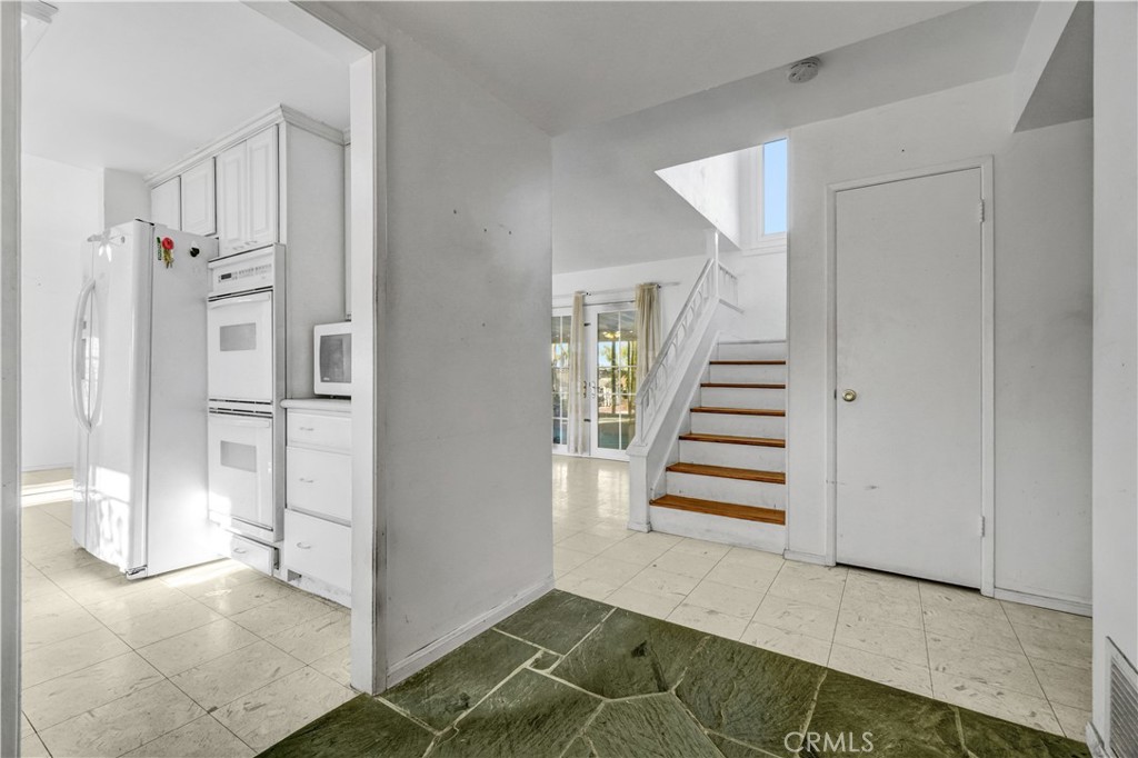 23141 Tulip Street Lake Forest, CA 92630 - Photo 12 of 27 a view of a hallway with entryway and stairs