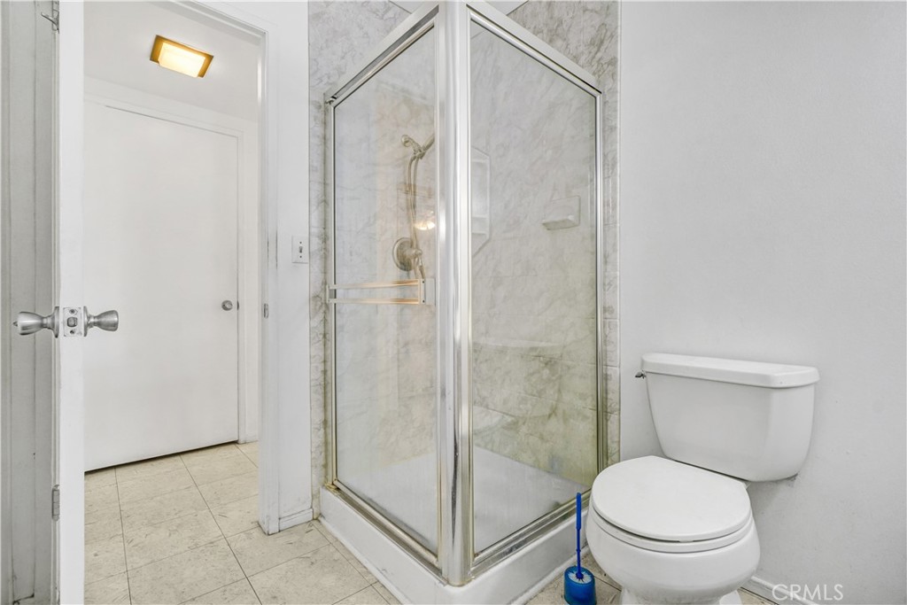 23141 Tulip Street Lake Forest, CA 92630 - Photo 15 of 27 a bathroom with a toilet and a shower