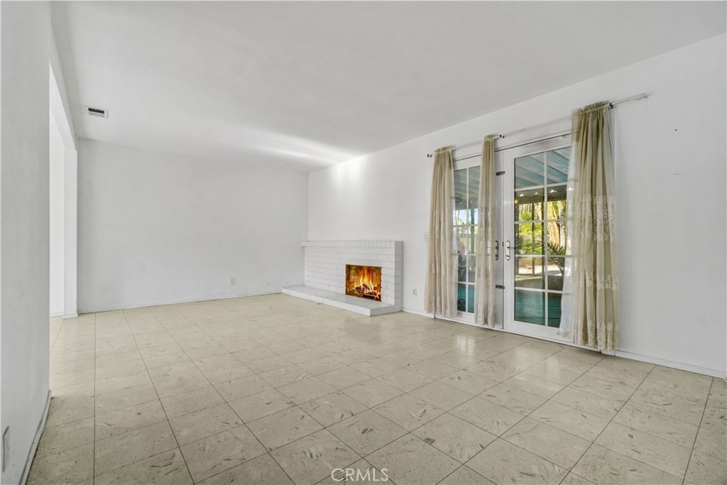 23141 Tulip Street Lake Forest, CA 92630 - Photo 18 of 27 a view of an empty room with a window and a fireplace