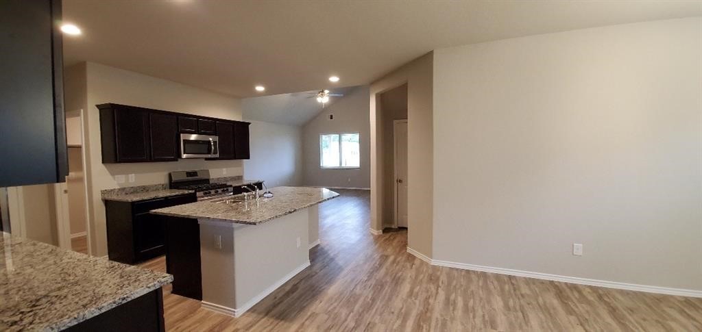 7723 London Tower Lane Houston, TX 77044 - Photo 5 of 11 a kitchen with a sink stove and microwave
