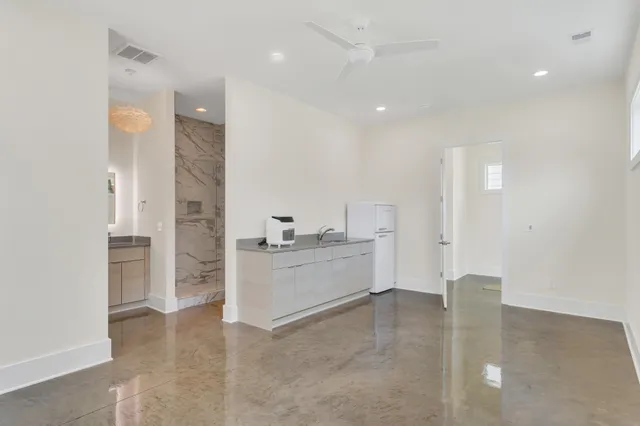 a spacious bathroom with a granite countertop sink a toilet and shower