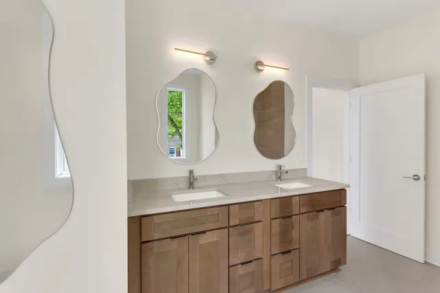 a bathroom with a double vanity sink and a mirror