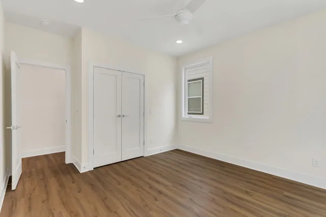a view of a room with wooden floor and white walls