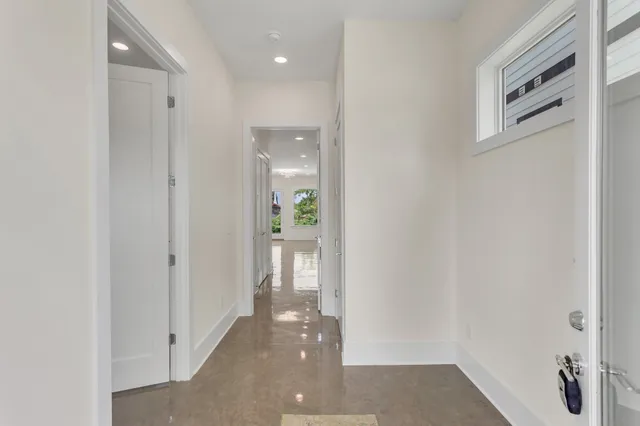a view of a hallway with wooden floor and closet