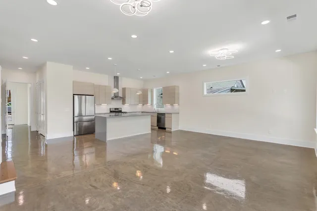 a view of kitchen with kitchen island and stainless steel appliances
