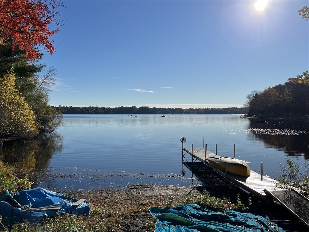 25 Sturges Road, Unit 2 Sharon, MA 02067 - Photo 2 of 28 a view of a lake with lawn chairs and a large tree