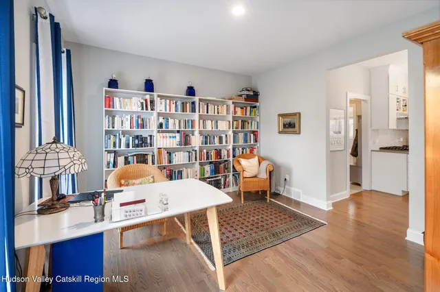 a living room with furniture and a book shelf