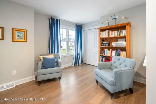 a living room with furniture and a book shelf