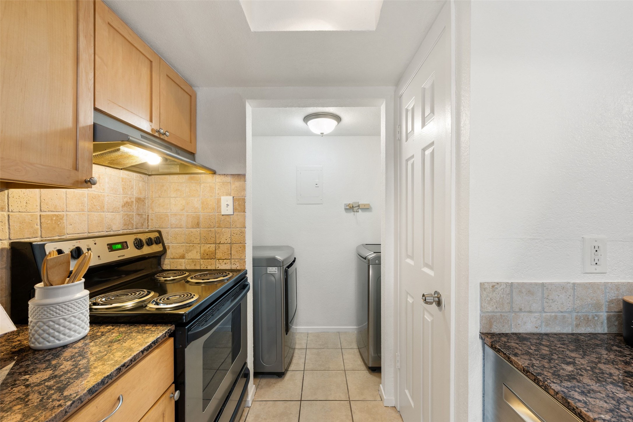 3627 Menchaca Road, Unit 105 Austin, TX 78704 - Photo 21 of 26 Kitchen with granite countertops and washer/dryer in unit